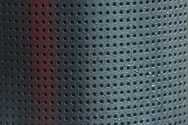 Perforated metal. Many holes in the iron sheet. Black perforated texture. Black dots on gray background