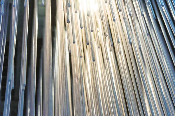 Abstract installation of plastic tubes in the interior. The texture of the set of plastic elements. Warm light and direct shape. Modern Art. A lot of tubes on the ceiling. Unusual chandelier.