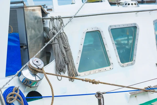 White yacht. Mooring and anchor ropes. Water transport. Black Sea. Mooring lines in front of a white yacht.