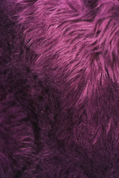 Texture of purple fur. Artificial color fur. Fur in the interior. Vegan fur.