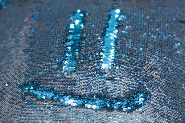 Double-sided sequins. Blue and silver sequins. Pillow with sequins and smiley.