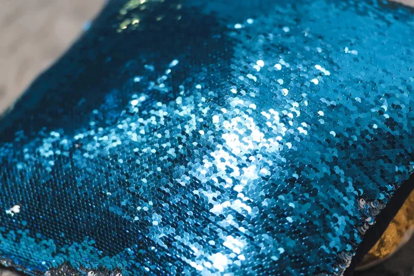 Double-sided sequins. Blue and silver sequins. Stylish pillow with sequins.