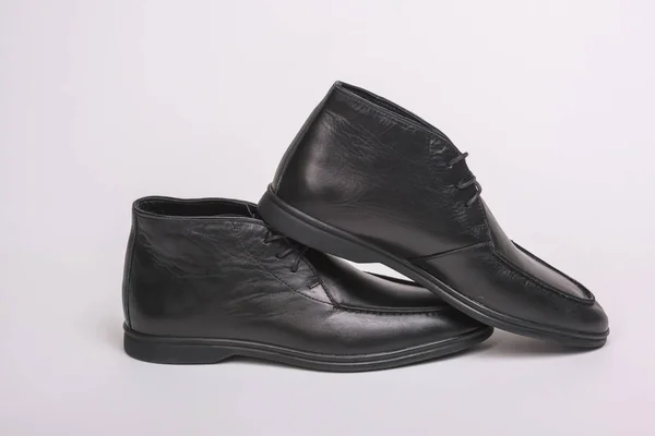 Black men's shoes with white sole. Men's shoes on a white background. Casual shoes. Comfortable men's shoes