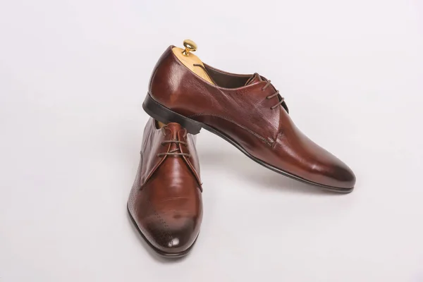 Leather men's shoes with lacing. Men's shoes on a white background. Brown oxford boots with laces