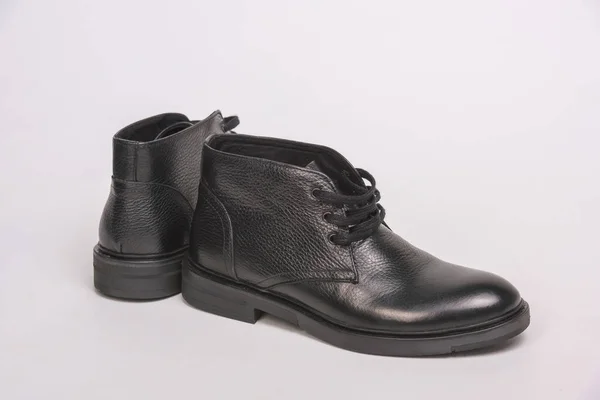 Black men's boots with laces. Men's shoes on a white background. Black chukka shoes.