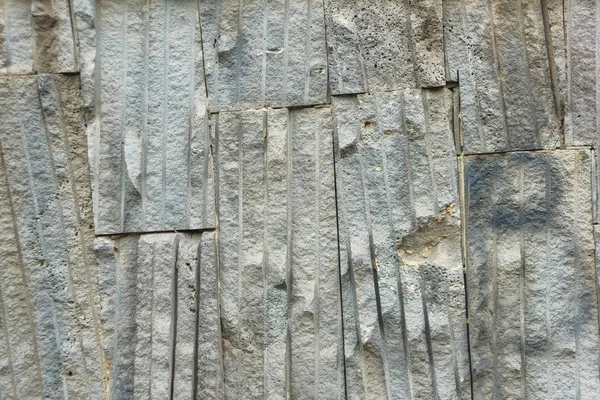 The texture of artificial stone coating. Architecture in Tbilisi. Decoration of the building with artificial stone.