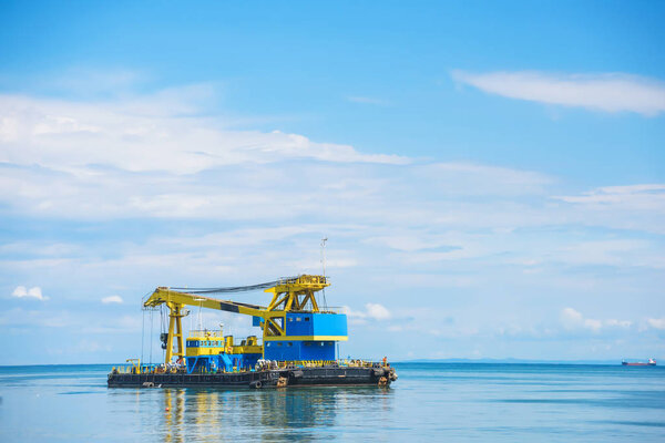 Port in Batumi. Large water crane for lifting loads. Rest in Georgia. Floating crane in the port.