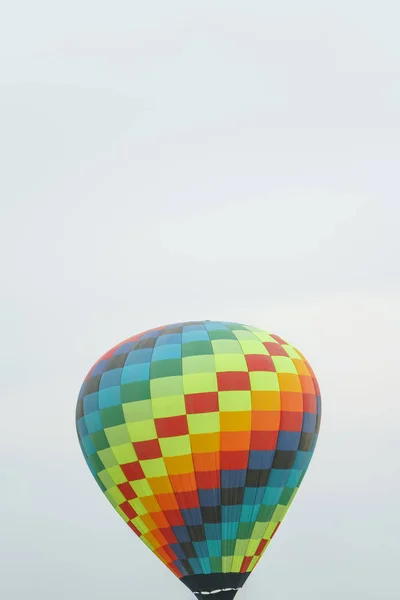 Multicolored hot air balloon on a blue sky background. Hot Air Balloons on Balloon Festival. Balloon Festival in Kazakhstan. Flying on balloons in the afternoon.