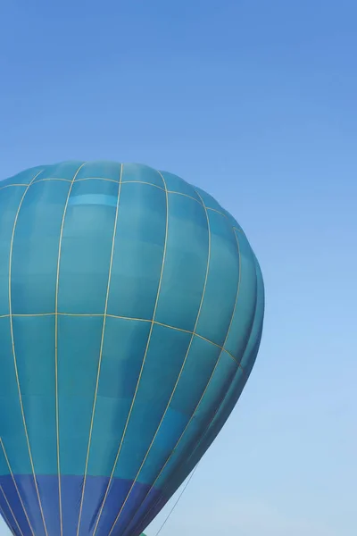 Light blue color hot air balloon on a blue sky background. Hot Air Balloons on Balloon Festival. Balloon Festival in Kazakhstan. Flying on balloons in the daytime.