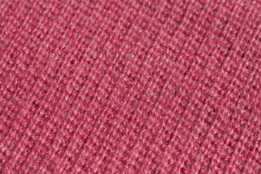 Örme pembe kumaş dokusu. Pembe soyut arka plan. Açık pembe kalın kış kumaş