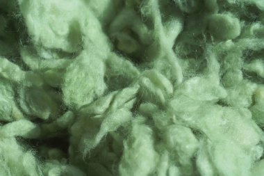 İplik için açık yeşil yün dokusu. Yeşil soyut arka plan. Örgü için renkli yün.