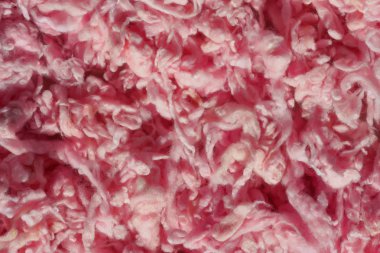 İplik için açık pembe yün doku. Pembe soyut arka plan. Örgü ve keçe için renkli yün.