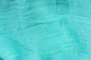 Açık mavi kumaş dokusu. Turkuaz soyut arka plan. Kumaş lacivert yakın çekim.