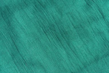 Deniz yeşili kumaş dokusu. Zümrüt soyut arka plan. Yeşil kumaş closeup.