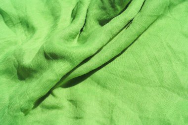 Açık yeşil kumaş dokusu. Açık yeşil soyut arka plan. Yeşil kumaş closeup.