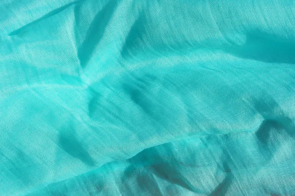 Texture of light blue fabric. Turquoise abstract background. Fabric navy blue close-up.