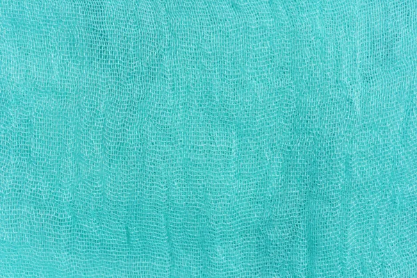 Texture of light blue fabric. Turquoise abstract background. Fabric navy blue close-up.