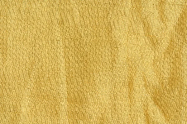 Açık sarı kumaş dokusu. Bej tekstil malzemesi dokusu. Sarı-yeşil eşarp.