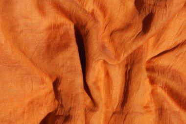Turuncu kumaş dokusu. Doku t açık kahverengi tekstil malzemesidir. Auburn eşarp yakın çekim. Koyu Sarı Palatine.
