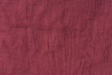 Koyu pembe kumaş dokusu. Kumaş rengi Marsala dokusu. Bordo atkı yakın çekim. Kadın kırmızı çaldı.