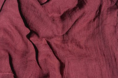 Koyu pembe kumaş dokusu. Kumaş rengi Marsala dokusu. Bordo atkı yakın çekim. Kadın kırmızı çaldı.