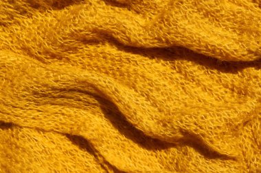 Sarı renk örme kumaş doku. Parlak sarı soyut arka plan. Kumaş hardal rengi.