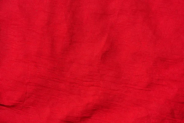 Texture of red fabric. Red scarf close up. Female red stole.