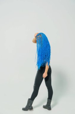 Beyaz arka planda mavi at kuyruklu Rus kızı. Bir kadının kafasında mavi zizi. Hafif bir arka plan üzerinde dreadlocks ile Eğitimli kız