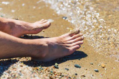 Göl sahilinde ayak adamı. Kırgızistan'da dinlenin. Issyk-Kul gölüne gezi.