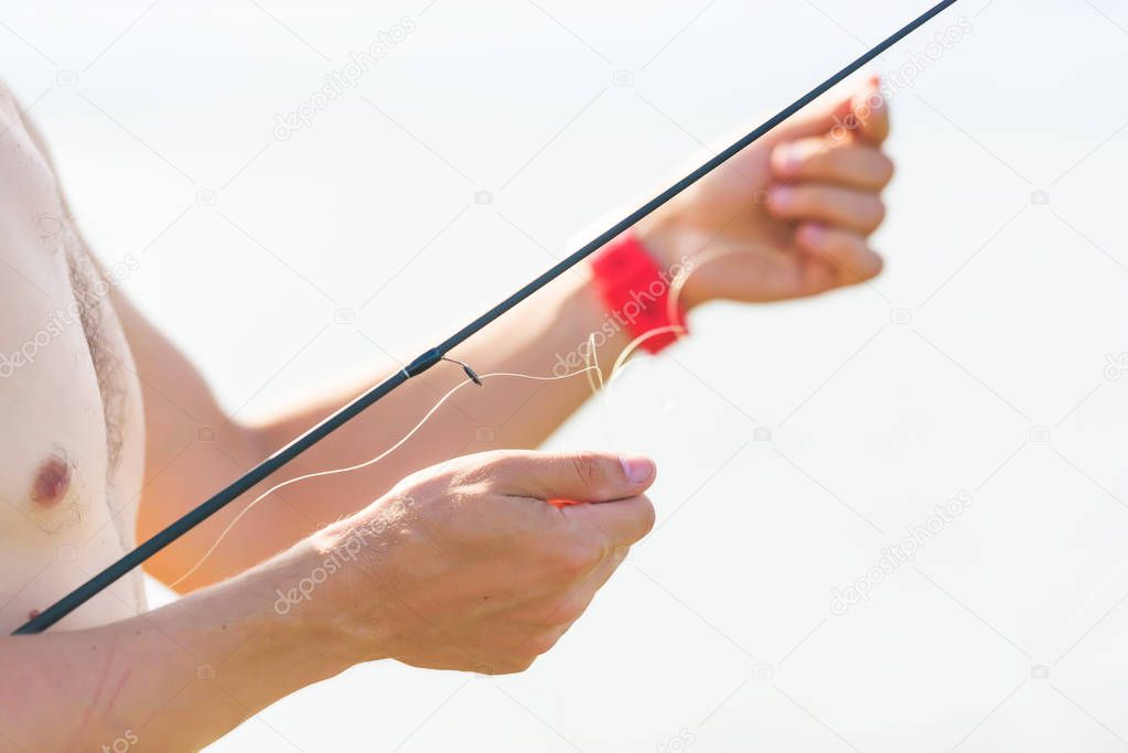 A man holding a fishing rod. Rest in Kyrgyzstan. Trip to Issyk Kul lake.