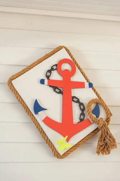 Decorative wooden anchor and ropes in the water park. Decorating in the nautical style of children\'s birthday. Sea anchor from plywood.