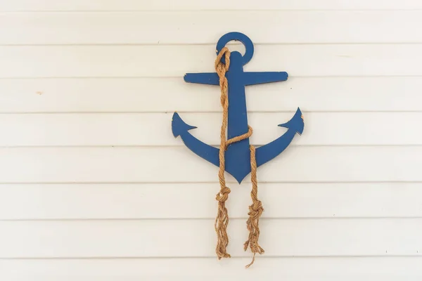 Decorative wooden anchor and ropes in the water park. Decorating in the nautical style of children\'s birthday. Sea anchor from plywood.