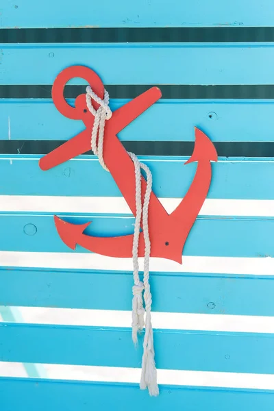 Decorative wooden anchor and ropes in the water park. Decorating in the nautical style of children\'s birthday. Sea anchor from plywood.