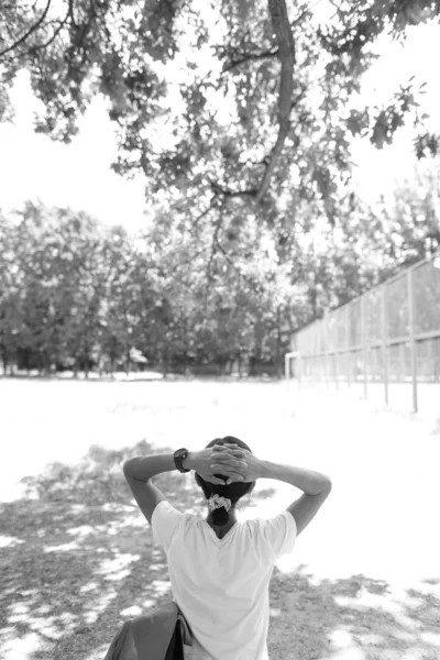 Girl resting on the bench after a run. Woman in uniform.