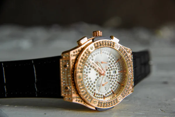 レザーストラップで腕時計を手首 男の時計だジュエリーアクセサリー 石と金メッキダイヤル — ストック写真