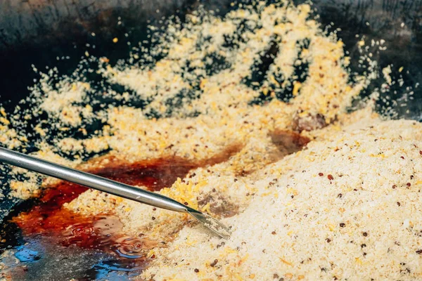 Büyük bir kazanda gerçek Özbek pilavı. Taşkent'teki pilav merkezi. Özbekistan'da ulusal yemekler pişirmek. Kazanda etli pilav. Geleneksel pilav pişirme