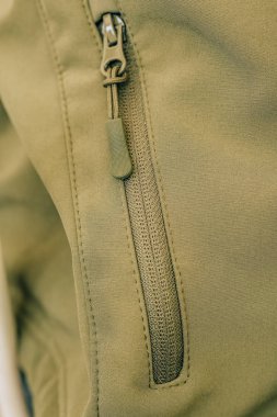 Ceketin üzerindeki fermuar. Sıcak haki ceket. Giysilerde dekoratif unsurlar.