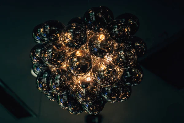 Decorative black glass chandelier. Volume round chandelier. lighting in the room.