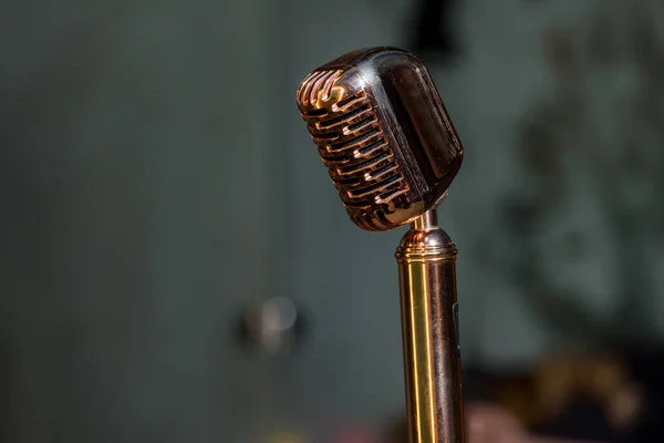 Vintage metal microphone. Scene with a microphone in the restaurant. Metal microphone on stand.