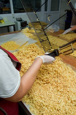 Şeker şurubu içinde pişirilen hamur örgü şeklinde dökülür. Şeker fabrikasında tatlı chak-chak pişirme. Hamur tatlı tatlı.