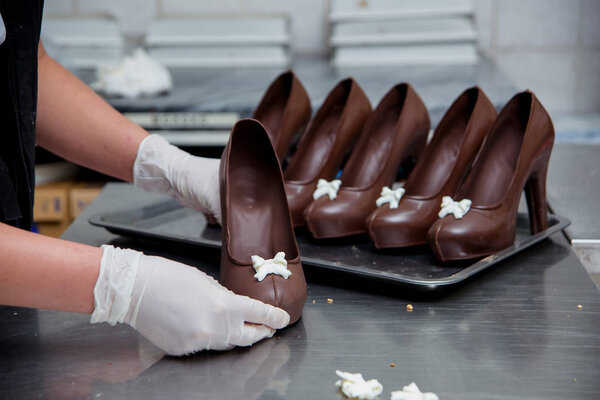 Chocolate Shoe. Preparation of milk chocolate at the candy factory. Sweet dessert.