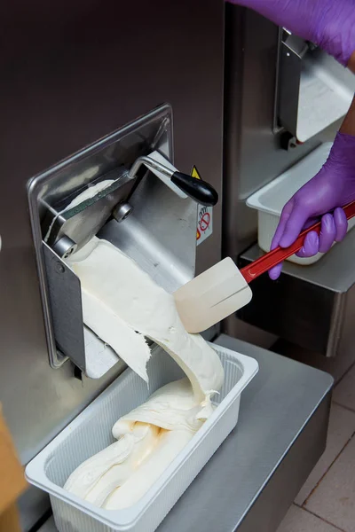 Preparation of ice cream at a candy factory. Distribution of ice cream on plastic forms. Sweet dessert.