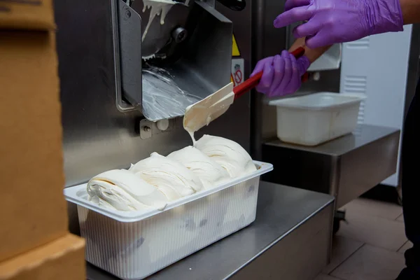 Preparation of ice cream at a candy factory. Distribution of ice cream on plastic forms. Sweet dessert.