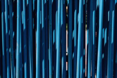 Mavi metal boruların dokusu. Geçici taşınabilir çitler. Mavi boyalı demir borular.