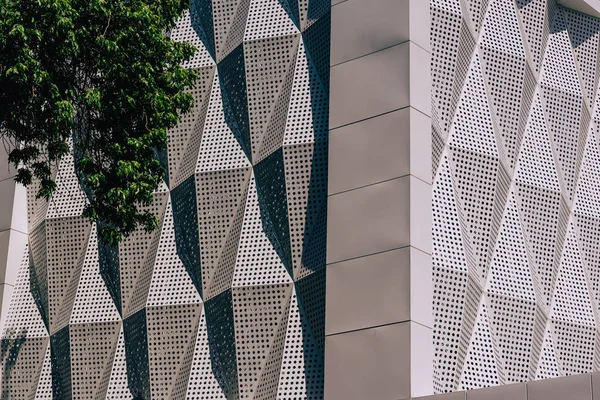 Metal facade of the building. Texture of embossed metal surface with holes. Walk along Arbat street in the city of Shymkent.