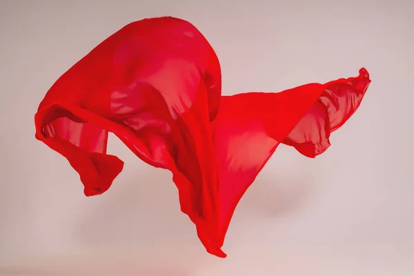 白色背景上的红色织物 在摄影棚里悬浮红色织物 高耸的棉织物 在浅色背景上飞行彩色织物 — 图库照片
