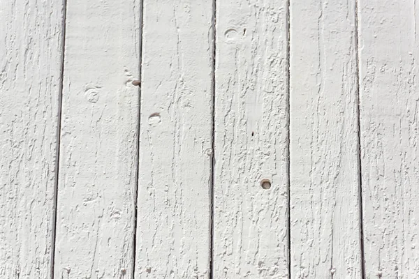 The texture of the wooden fence painted white. Wall of wood. White fence.