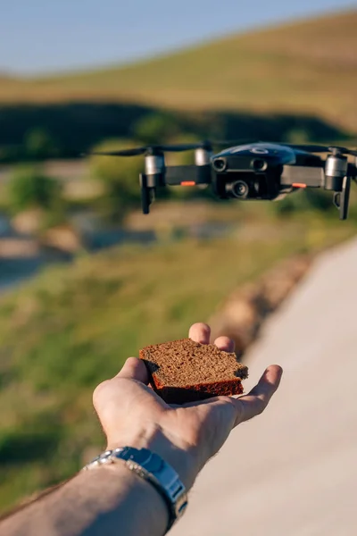 Landing a drone on hand. Luring the drone landing on the bread joke. Manual control of the drone. Jokes about copter how to catch a drone