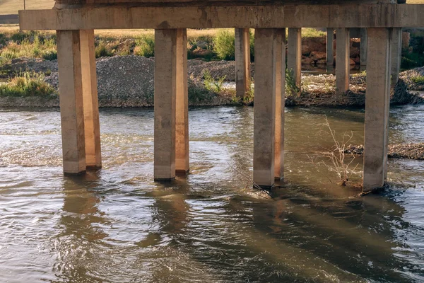 Concrete bridge supports in the river. Old concrete supports in the water. Bridge supports made of concrete