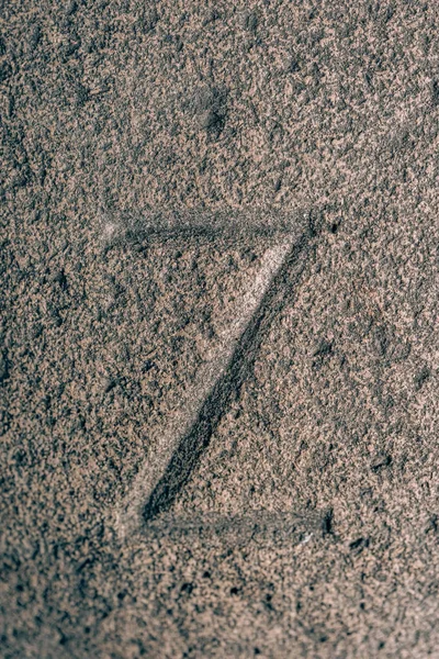 Z sign carved on the stone. Letter of the alphabet on granite. Stone engraving